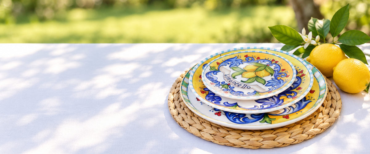 Limoncello plates with fresh lemons on a garden table